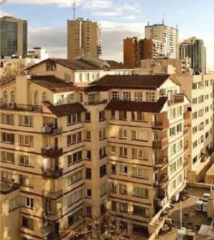 Front of zip tote bag with white canvas, black canvas straps and handle, and black zipper pulls.