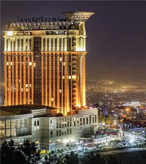 Front of zip tote bag with white canvas, black canvas straps and handle, and black zipper pulls.